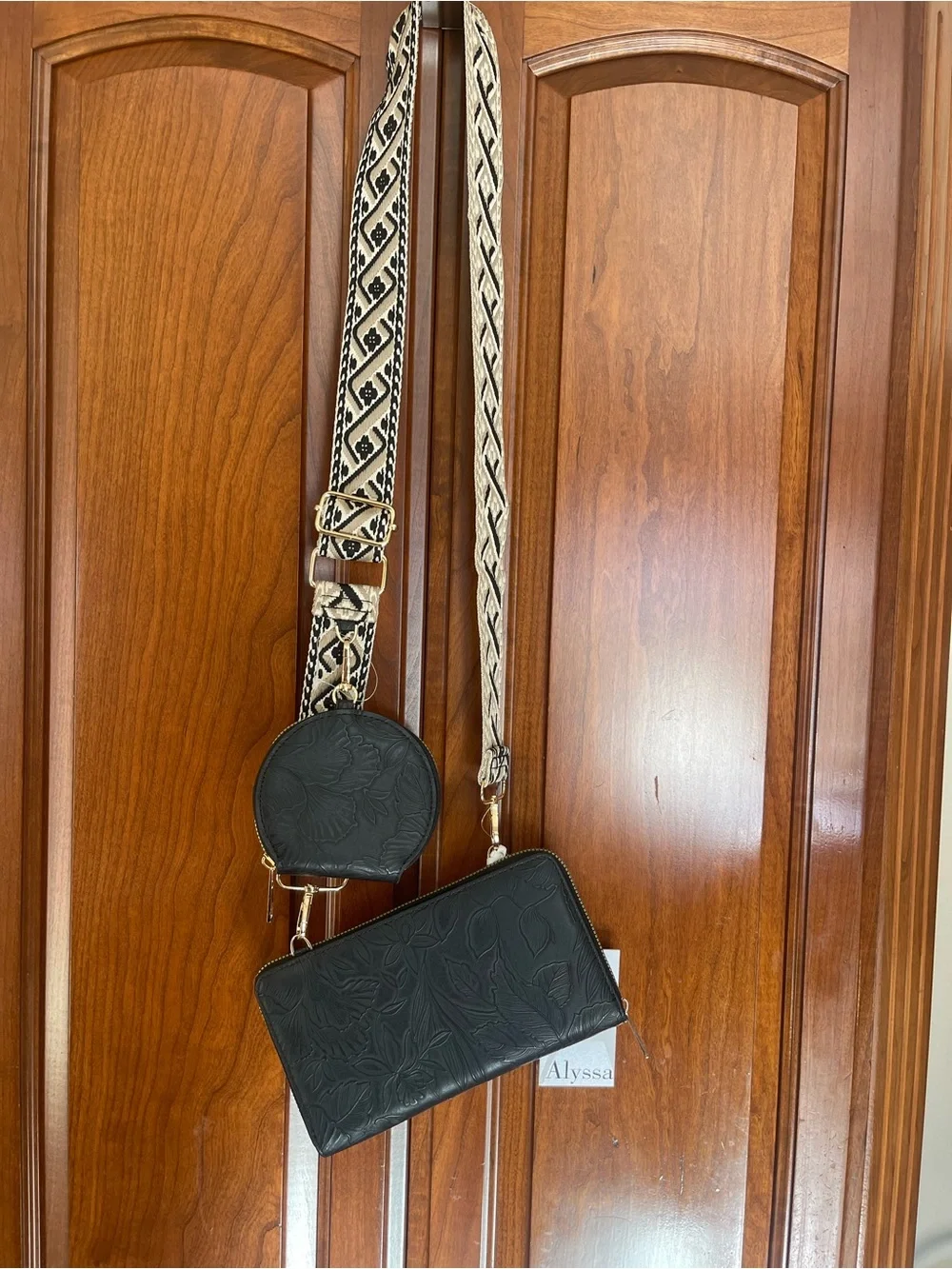 Black Embossed Crossbody Wallet with Patterned Strap and Coin Pouch